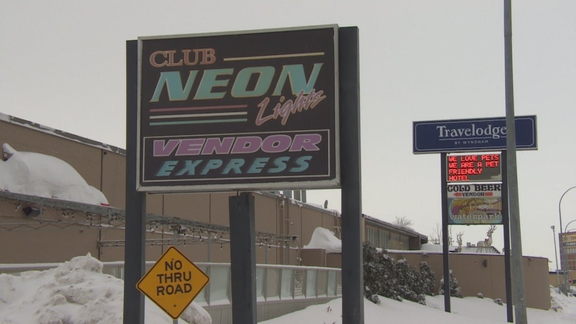 john-lloyd-maaba-barrion-homicide Signs for a beer vendor outside the building on a snowy day.