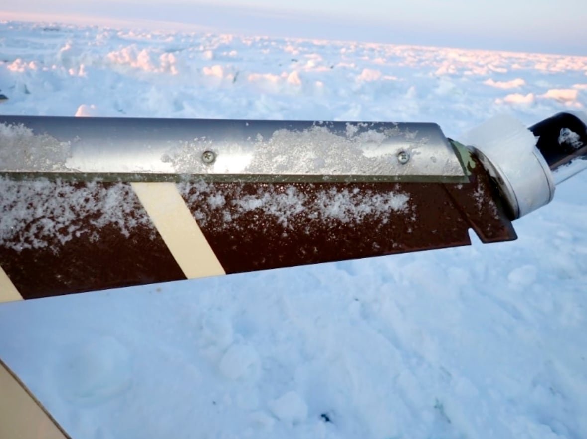 missing-plane-alaska-report-1 A part of an airplane covered in ice.