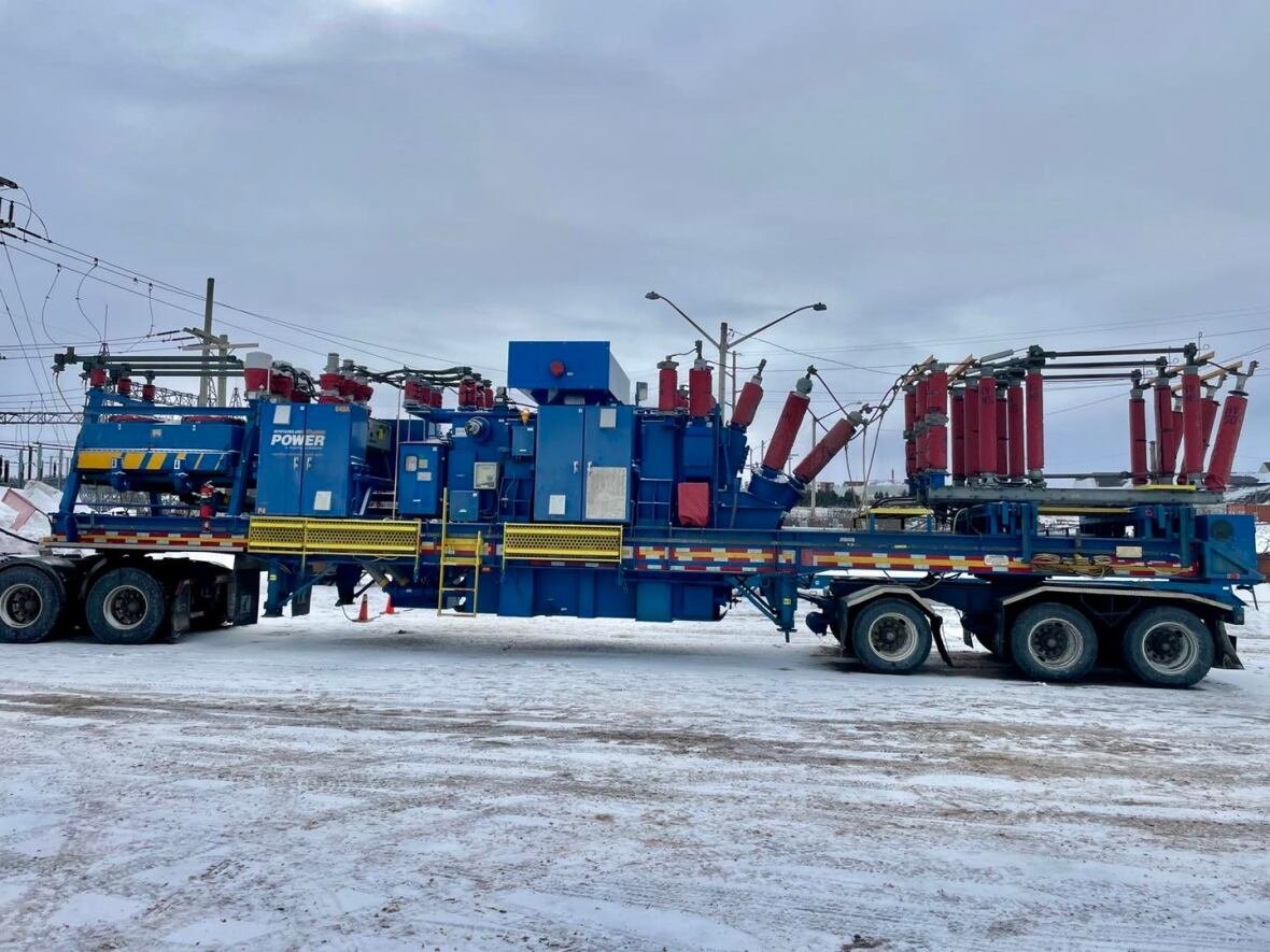 mobile-transformer a large mobile electrical power unit on a trailer in a snowy setting