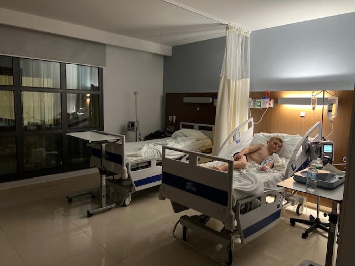 sandos-outbreak A child on a hospital bed.