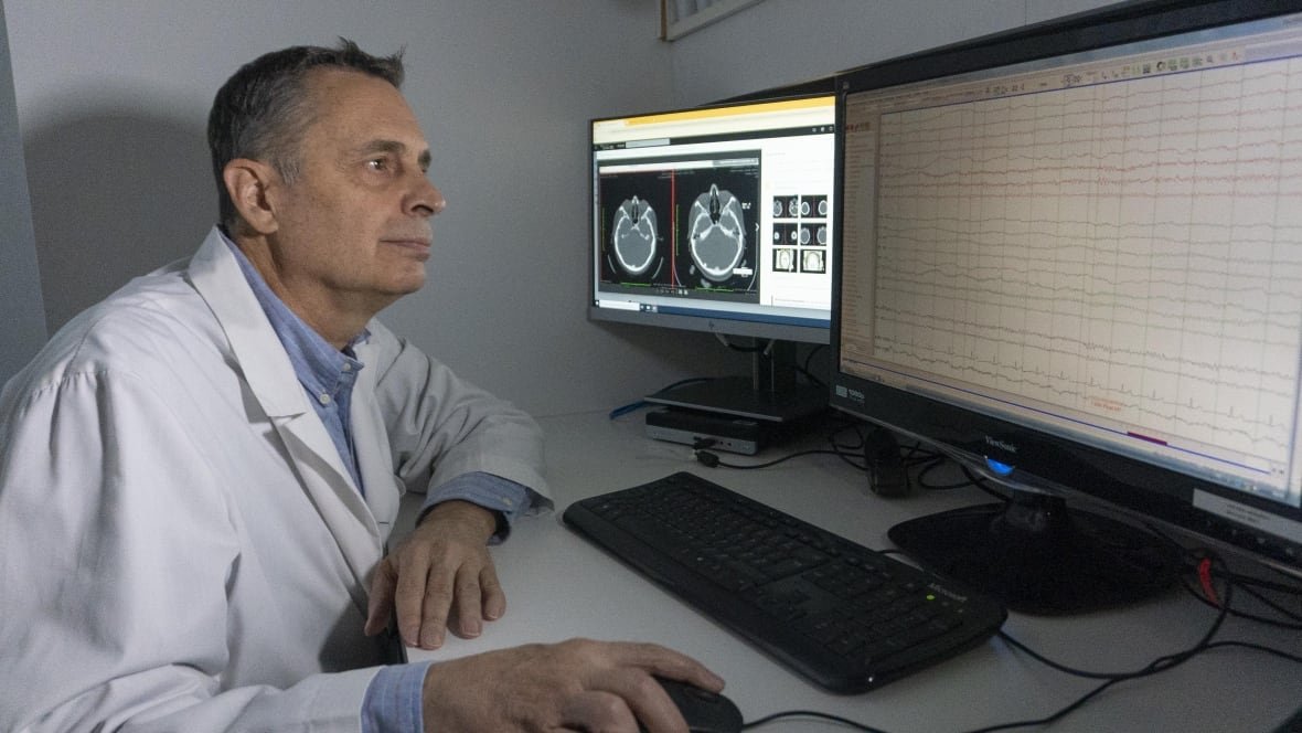 stephane-ledoux A medical professional sitting in front of a computer.