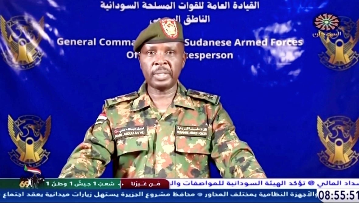 sudan-politics A dark complected man with a beard wearing military fatigues is shown speaking.