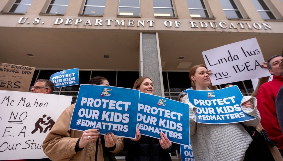 trump-department-of-education-1 People hold signs that say Protect Our Kids #EdMatters