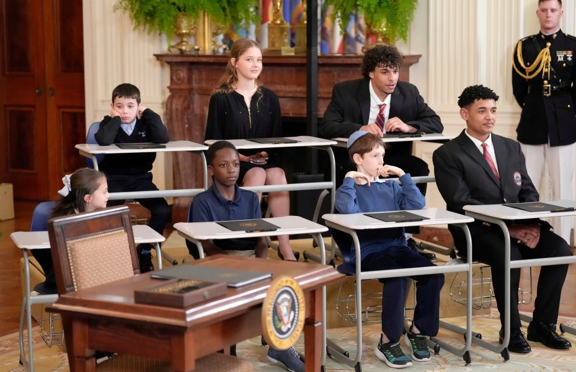 trump-department-of-education Children sit at desks in a room at the White House.