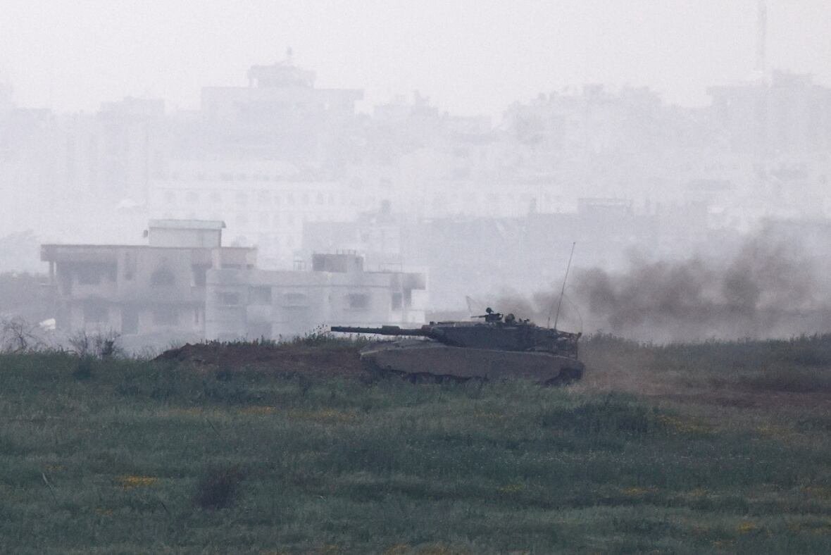 a-tank-drives-through-gaza A tank drives through a green field