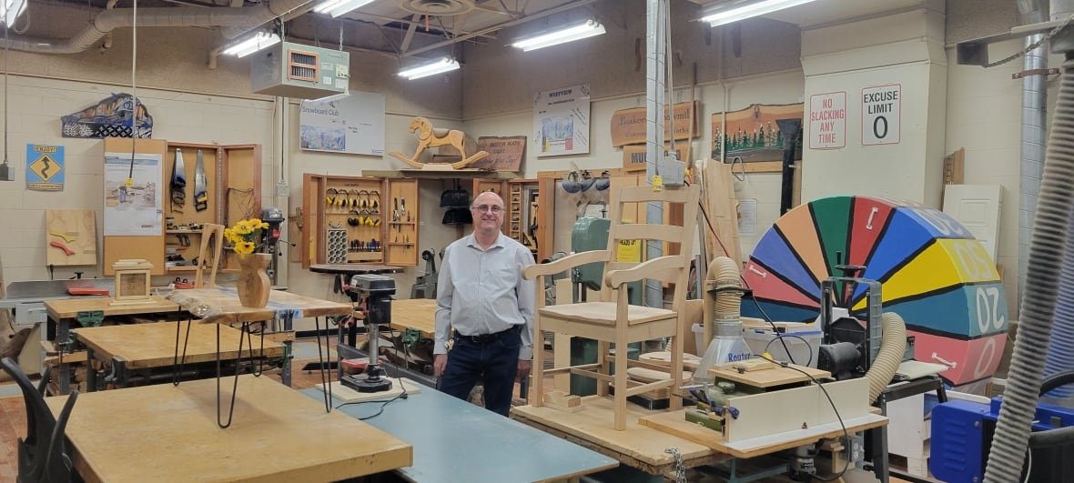 andy-strothotte A man stands in a high school woodworking shop.