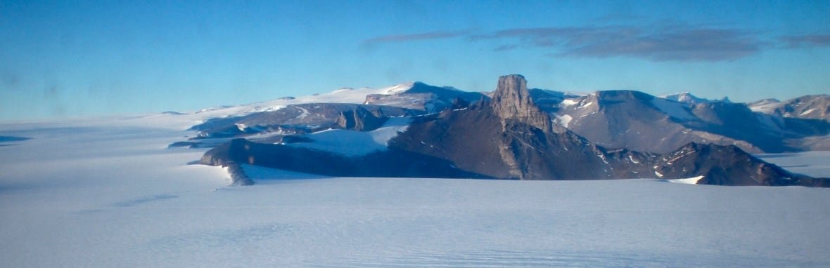 antarctica-over-the-ice An ice sheet with a mountain seen in the background.