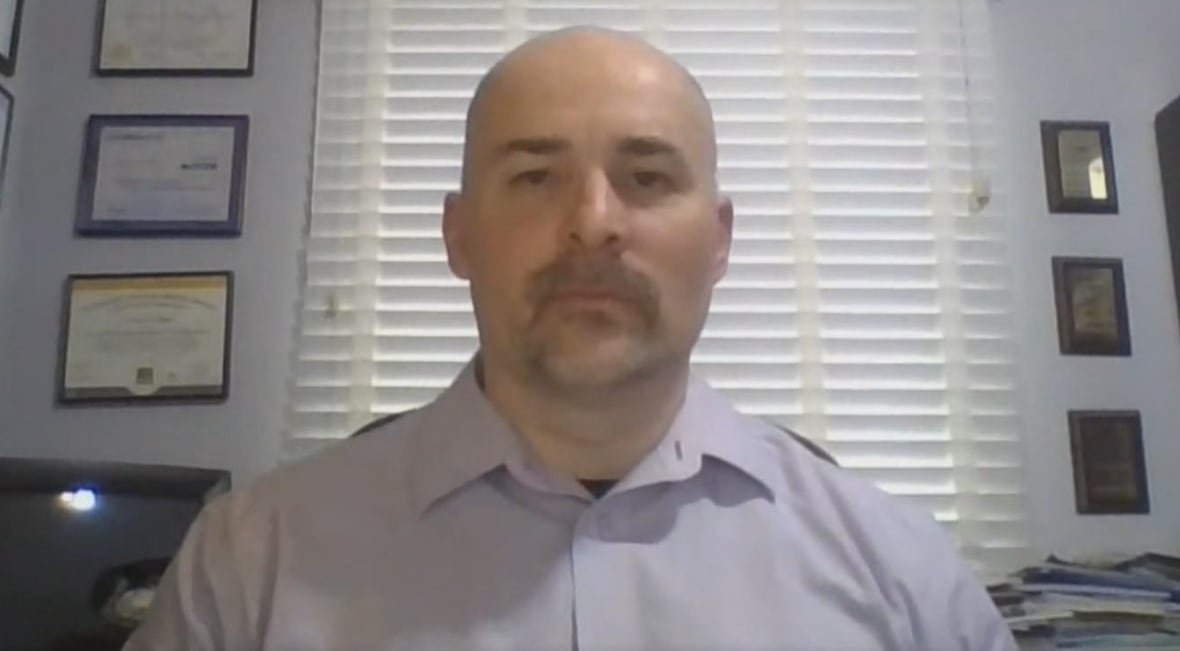 claudiu-popa Headshot of man on webcam in office.