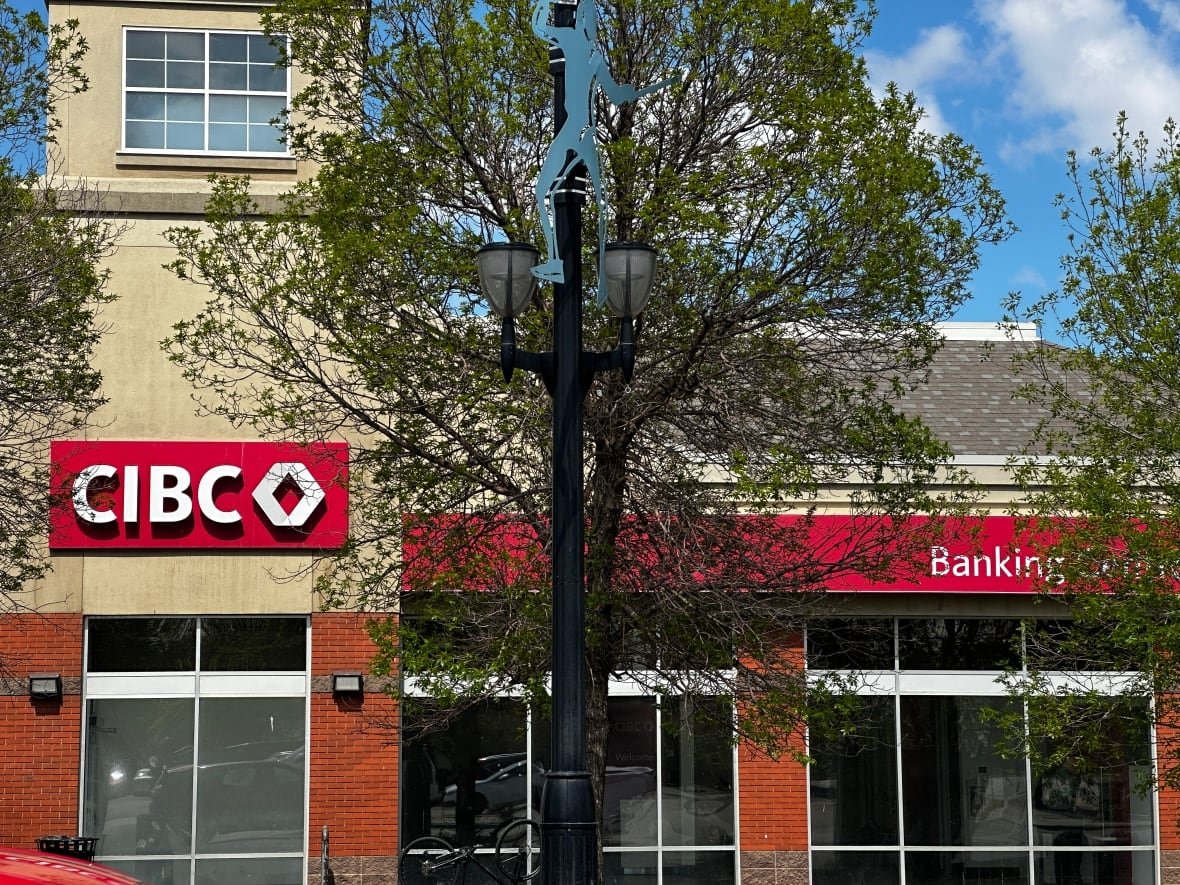 go-public-cibc-branch A CIBC bank is located on a tree-lined street.
