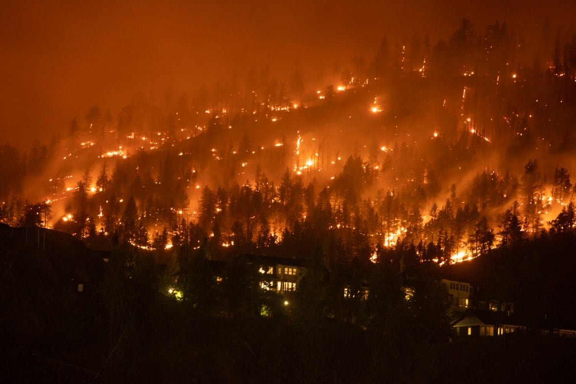 kelowna-wildfires Homes near a wildfire as it burns in West Kelowna, B.C., early in the morning