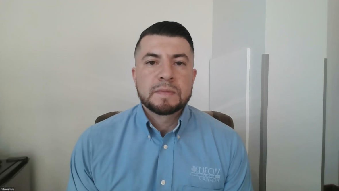 pablo-godoy A man wearing a blue shirt in an office.