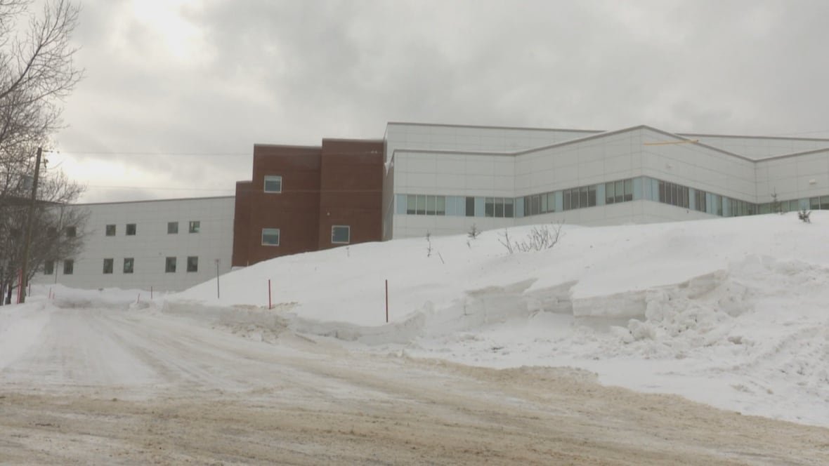 restigouche-hospital-centre A winter scene of a large building with a section in red bricks and the rest in white-siding.