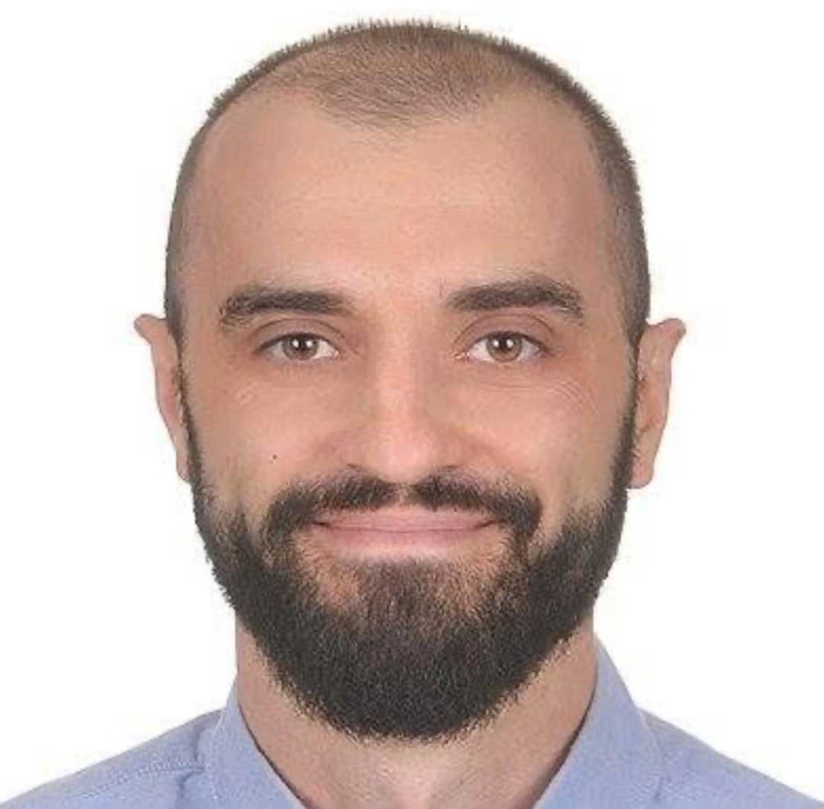 roman-kamyshnyy-45-of-saint-john-charged-with-two-counts-first-degree-murder-1 A smiling man with a beard, wearing a blue collared shirt.
