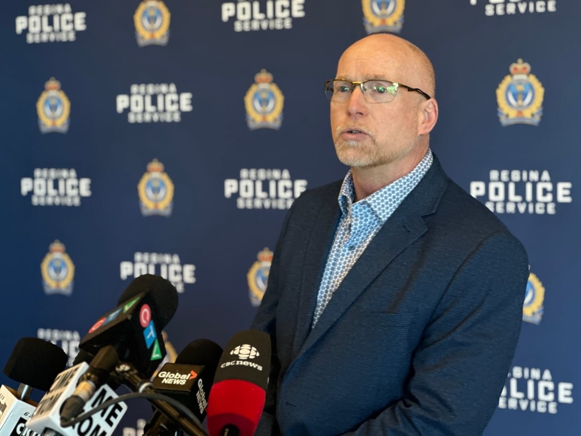 insp-gary-giroux A man in a dark blue suit stands at a podium.