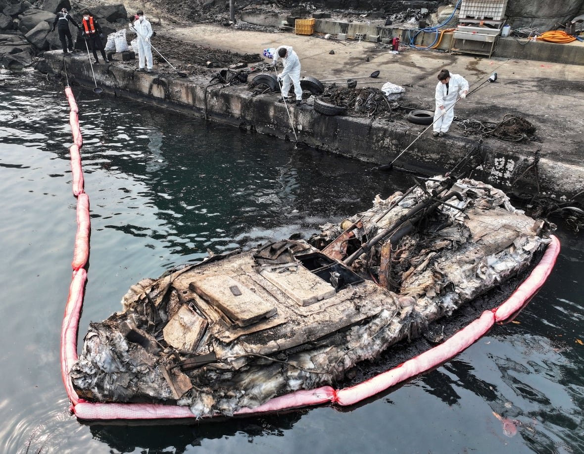 south-korea-wildfires-1 A burned-out fishing boat at a damaged port due to wildfires in Yeongdeok, South Korea