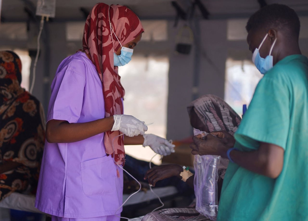 default-362 Sudanese medics prepare an infusion for patients suffering from cholera at the makeshift clinic run by the UN in Tawila, in August.