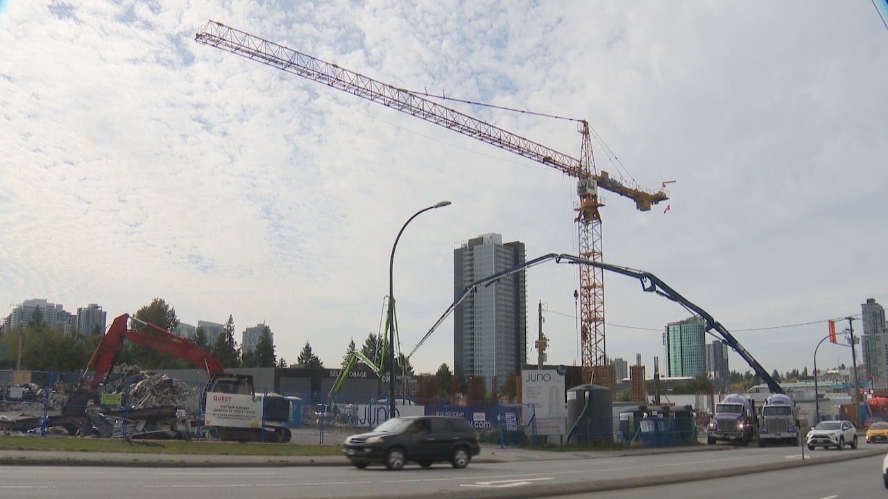 A large construction site, with concrete mixers and a crane.