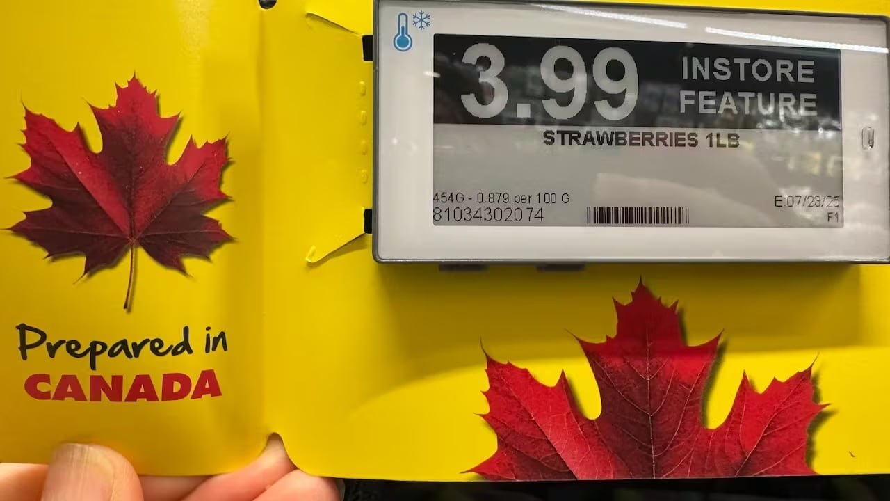 A sign in No Frills advertising strawberries with a red maple leaf and a "Prepared in Canada" declaration.