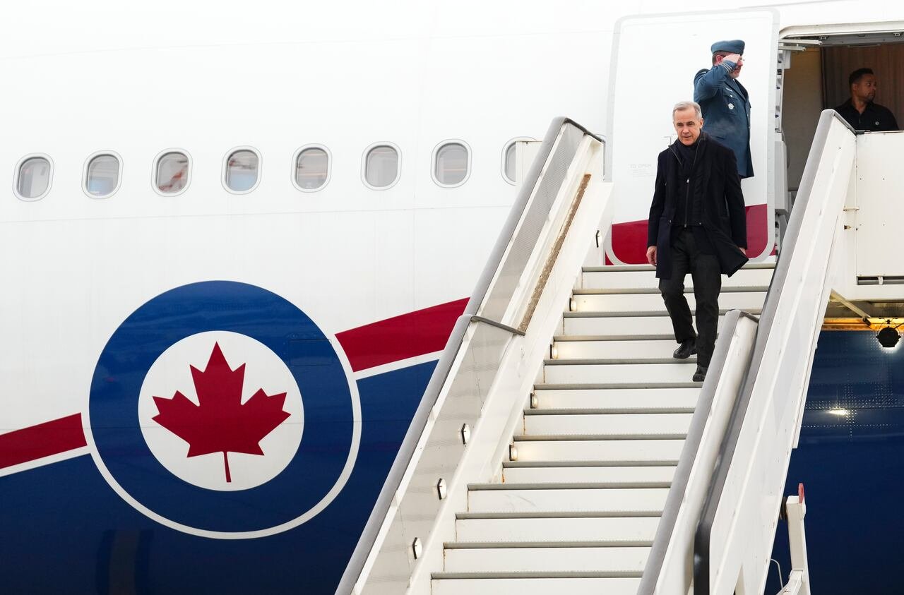 Carney shown walking down the stairs from the prime minister's jet to the tarmac in Davos, Switzerland.
