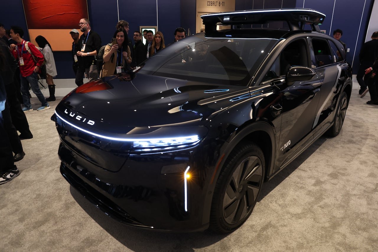 default-518 Robotaxi vehicle on display at a trade show.