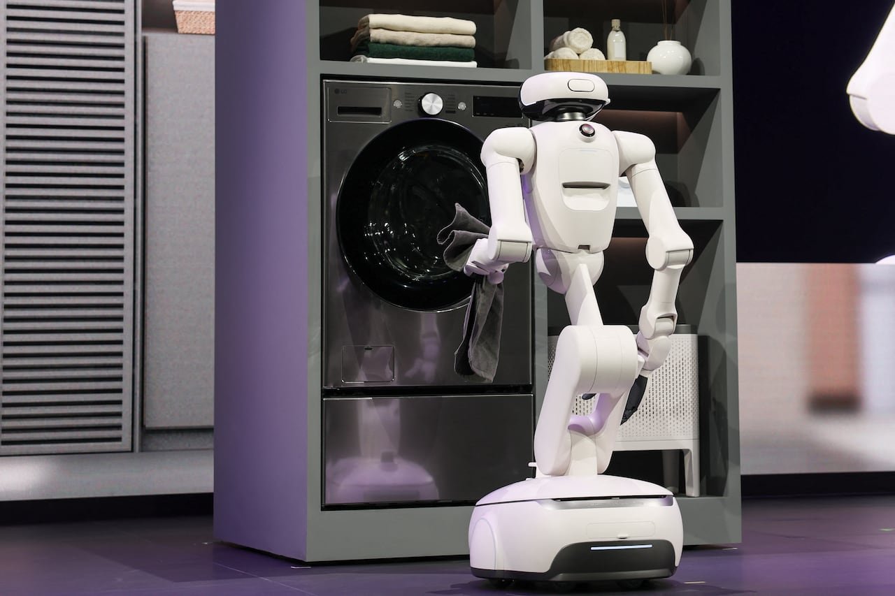 default-520 A white robot loading laundry.