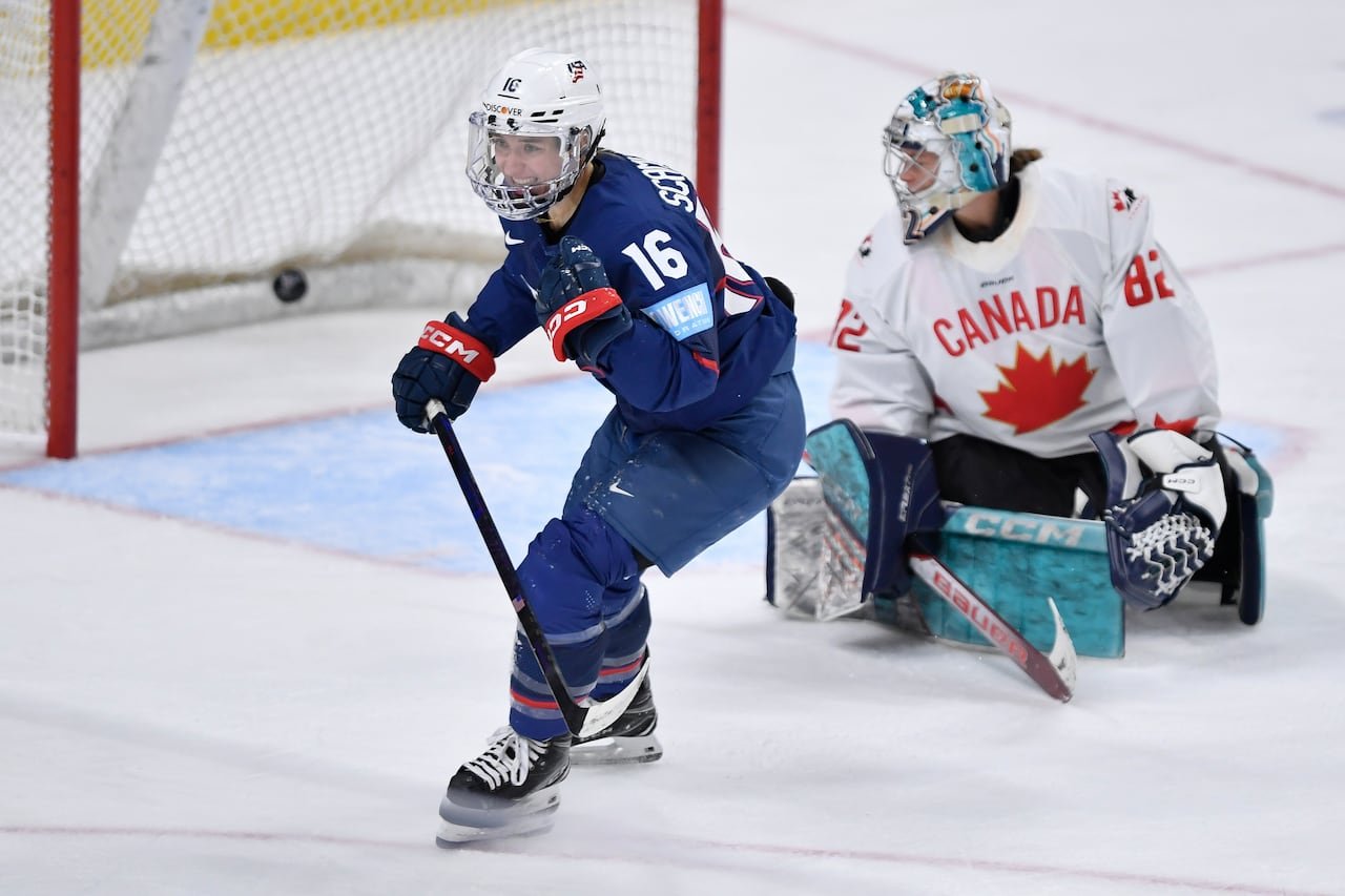 A hockey player celebrates after scoring a goal.