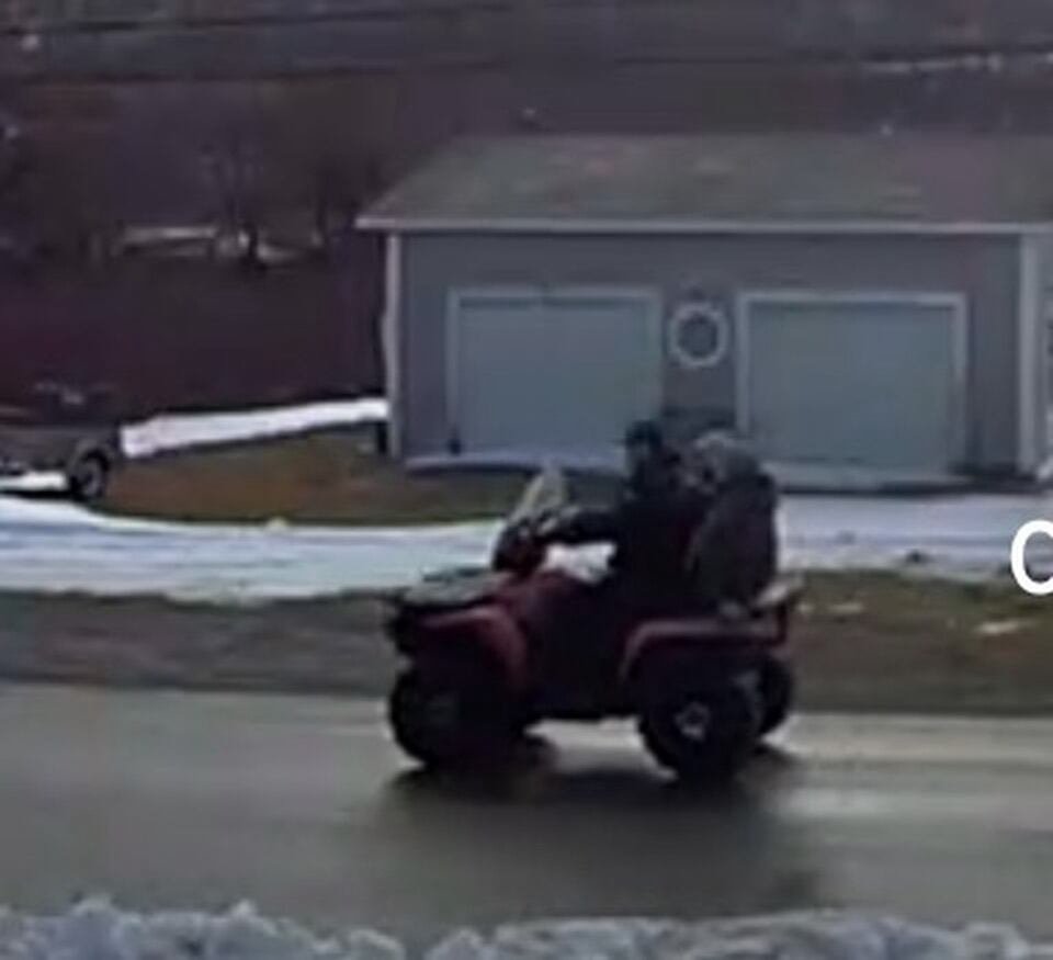 Two individuals on an ATV.