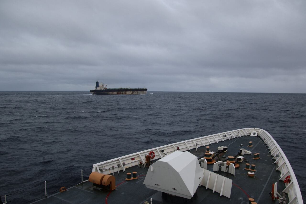 default-101 An older oil tanker is seen in the distance from the deck of another ship.