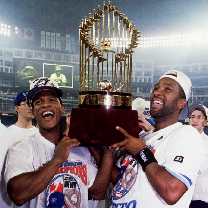 Two athletes hold a trophy